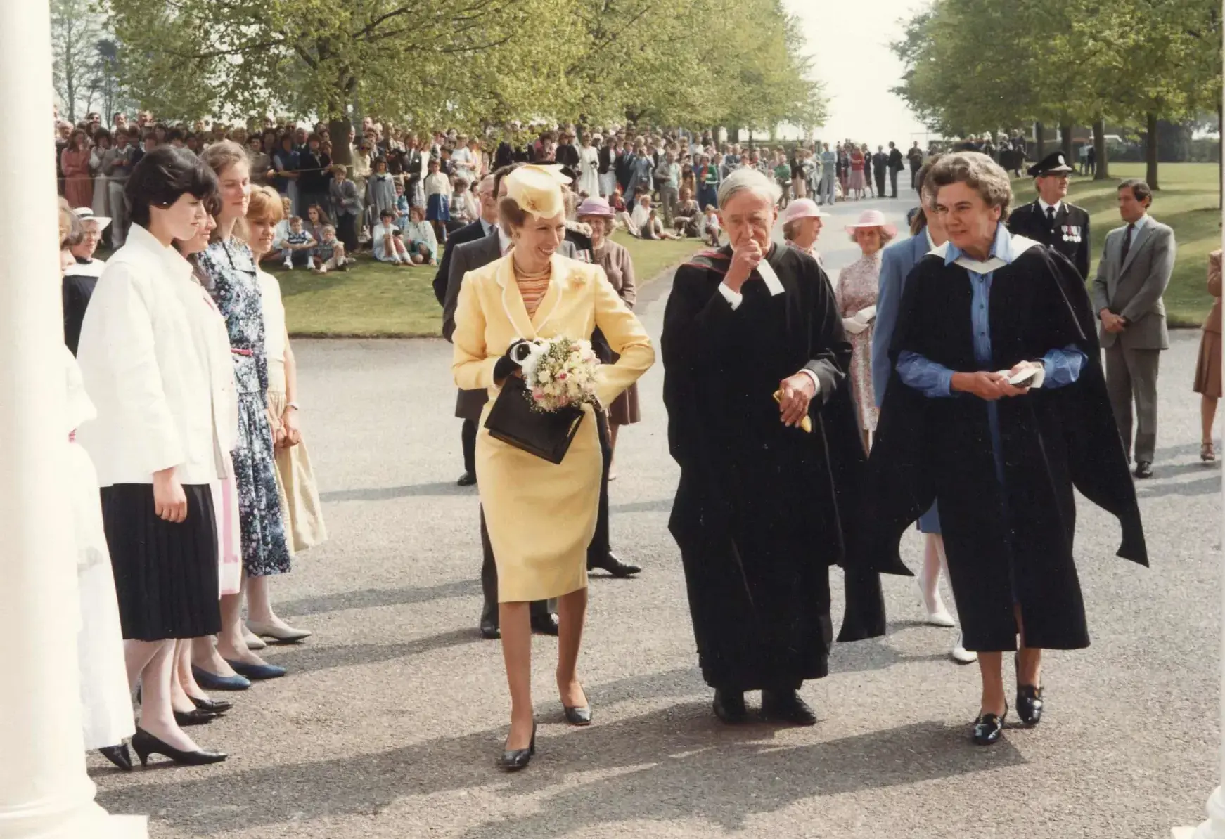 Princess Anne walking up stairs outside with a group of people