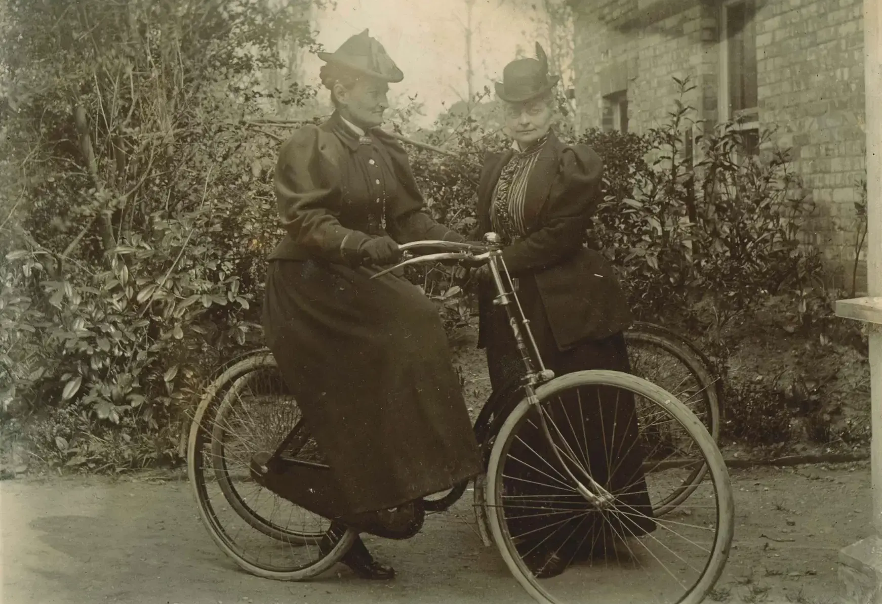 Two women on a Victorian bicycle