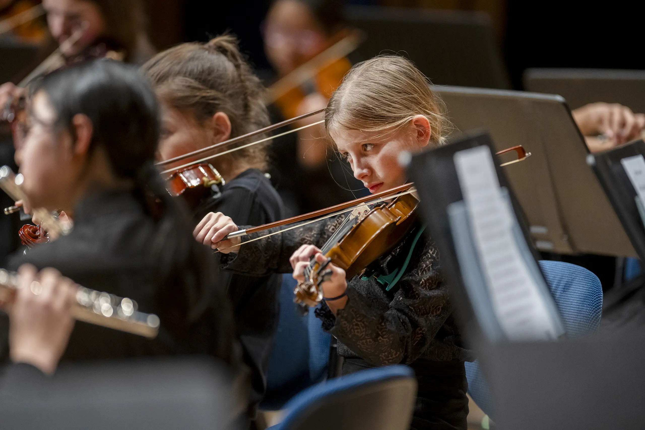 Girl playing violin in orchestra student 