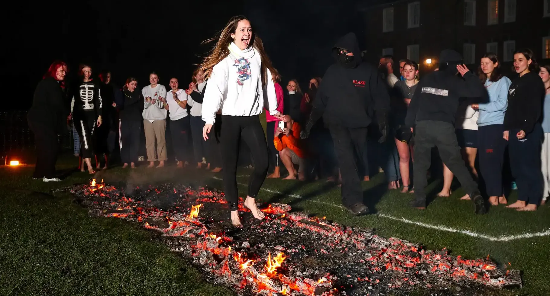 St Swithun’s student doing a fire walk to raise funds for the Bramston Foundation