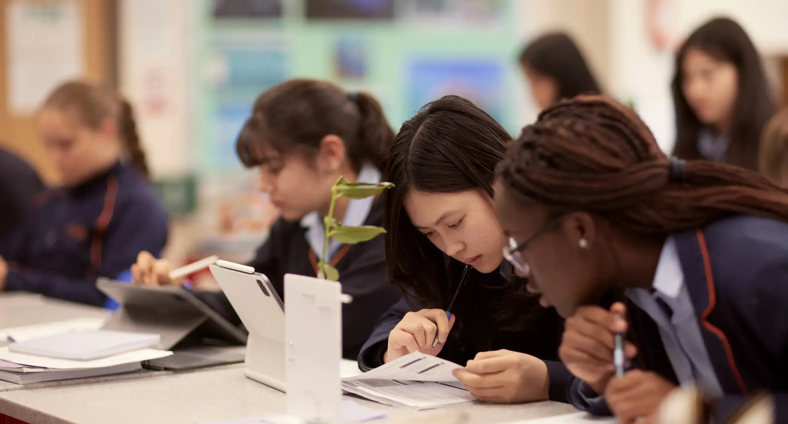 Three senior students in a biology lesson