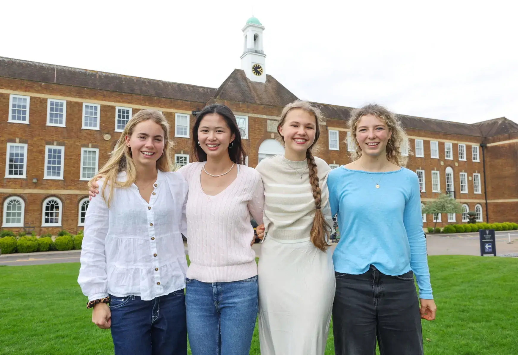 The head girl team standing arm in arm