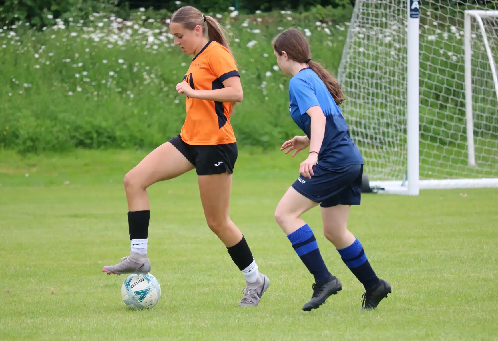 Two football players battle for possession