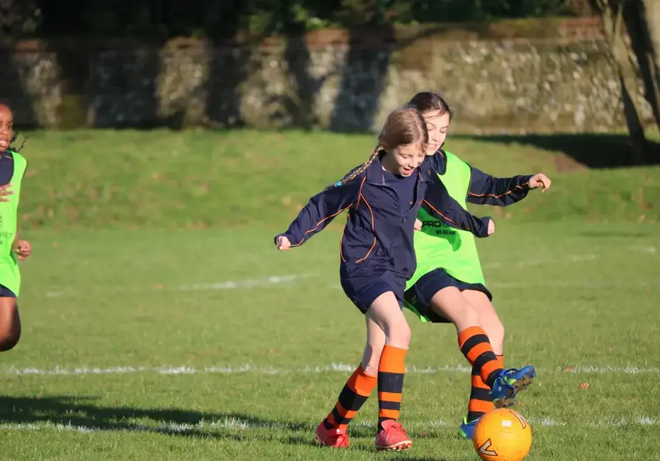 Prep school girl playing football