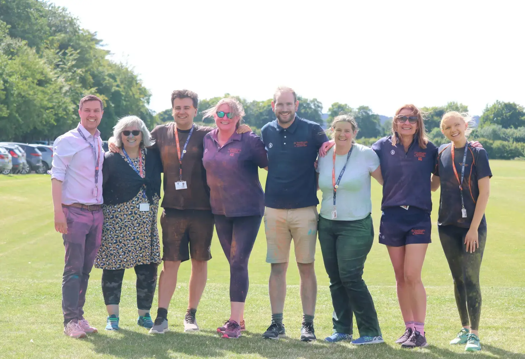 Teachers arm in arm on a pitch