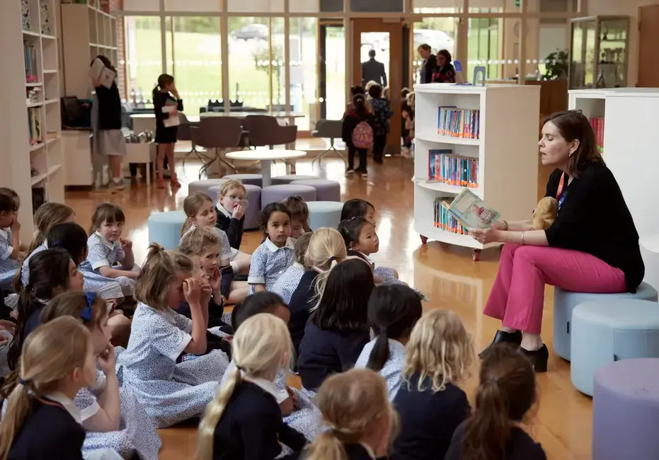 Teacher reading a book to children