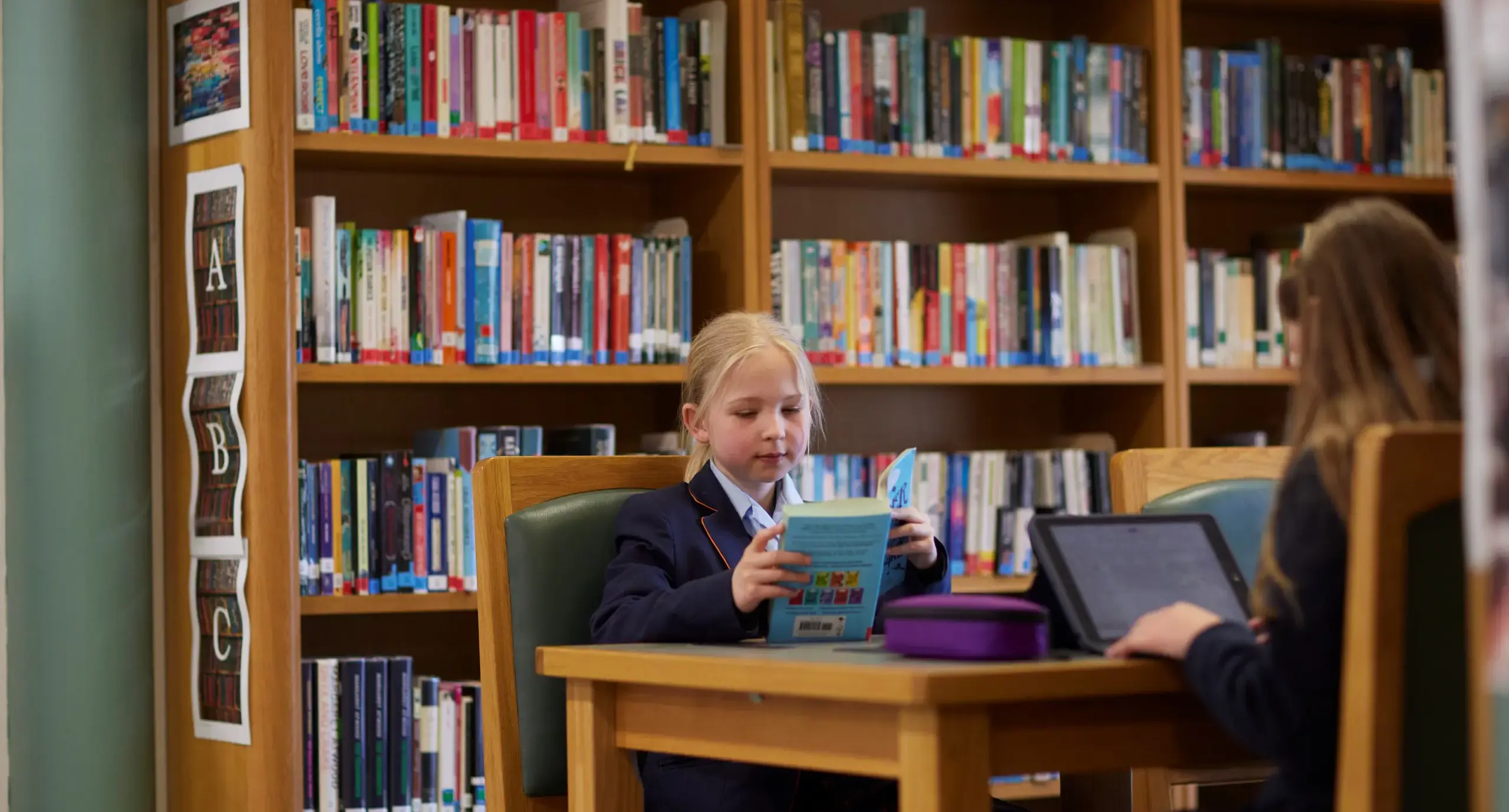 A St Swithun’s student enjoys reading a book in Bramston library