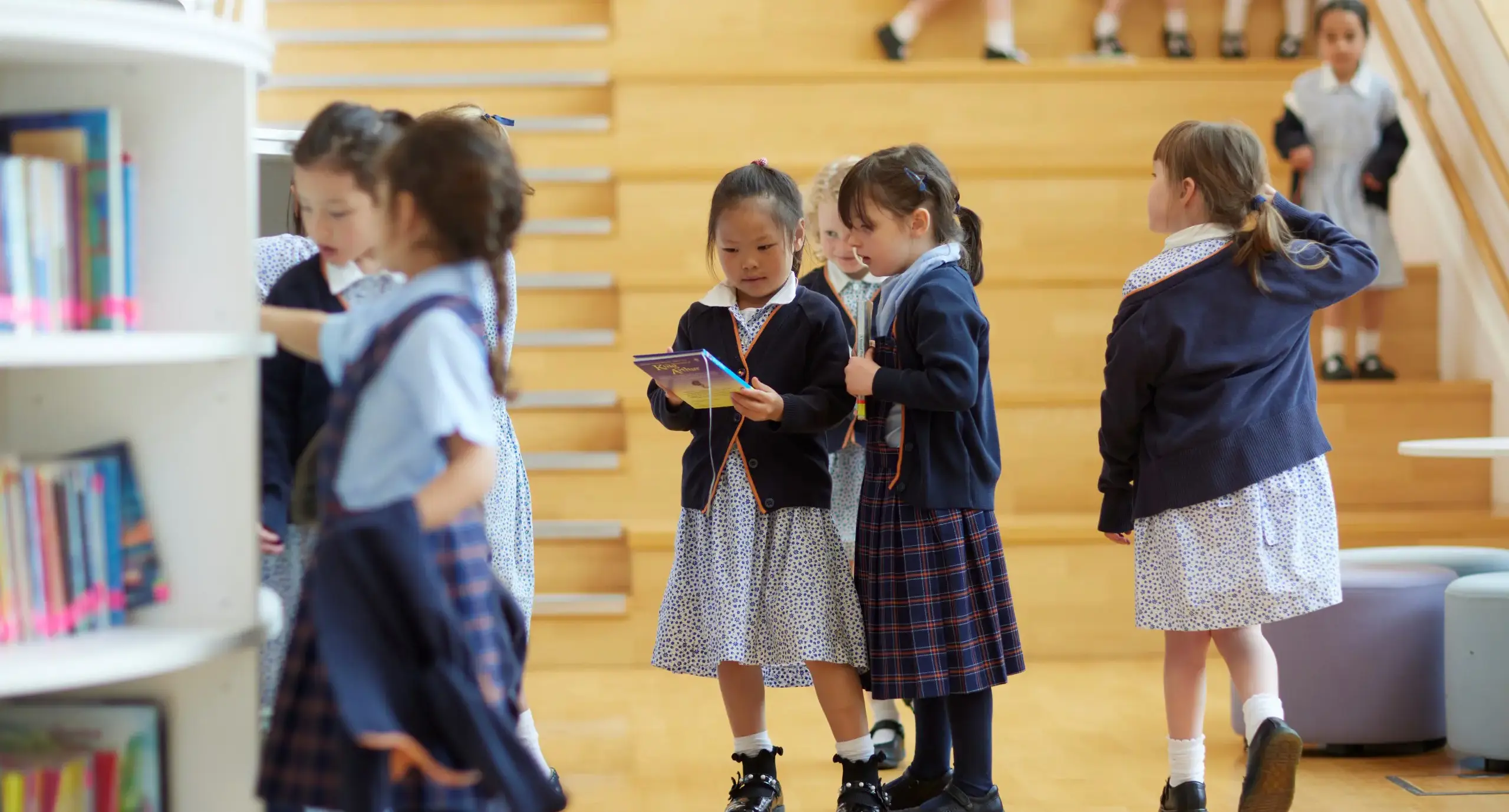 Prep school girls in the prep library choosing books