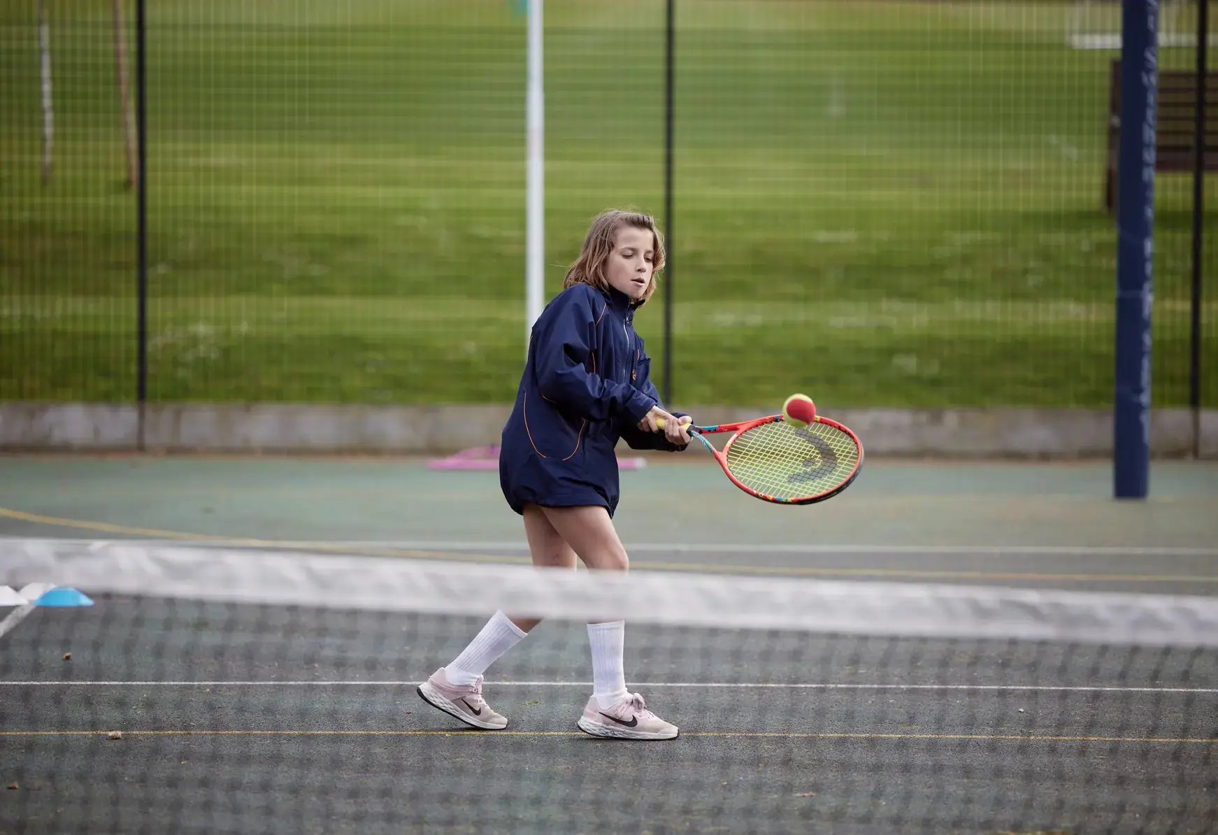 Student playing tennis