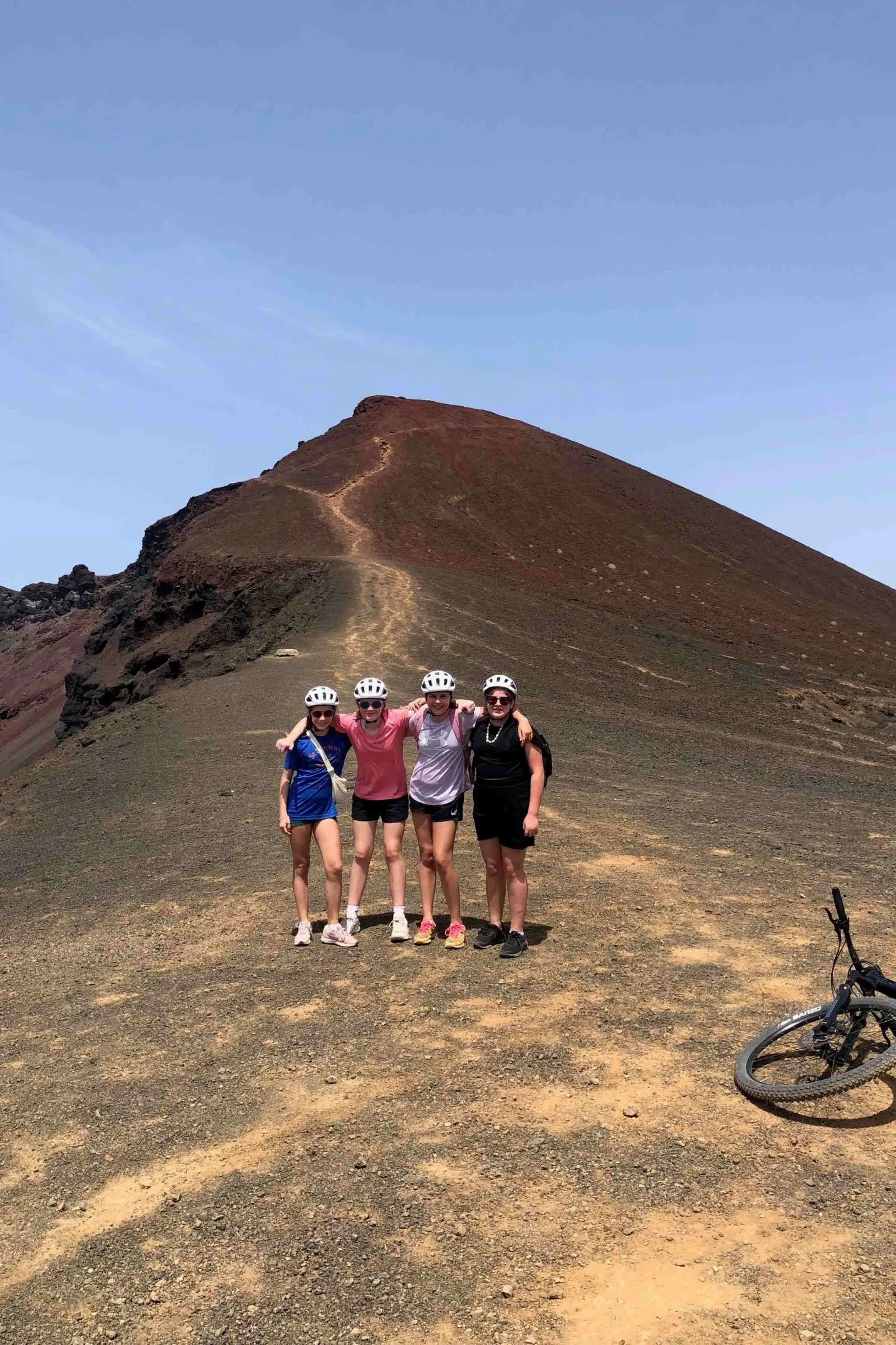 Students posing in front of a mountain biking trail