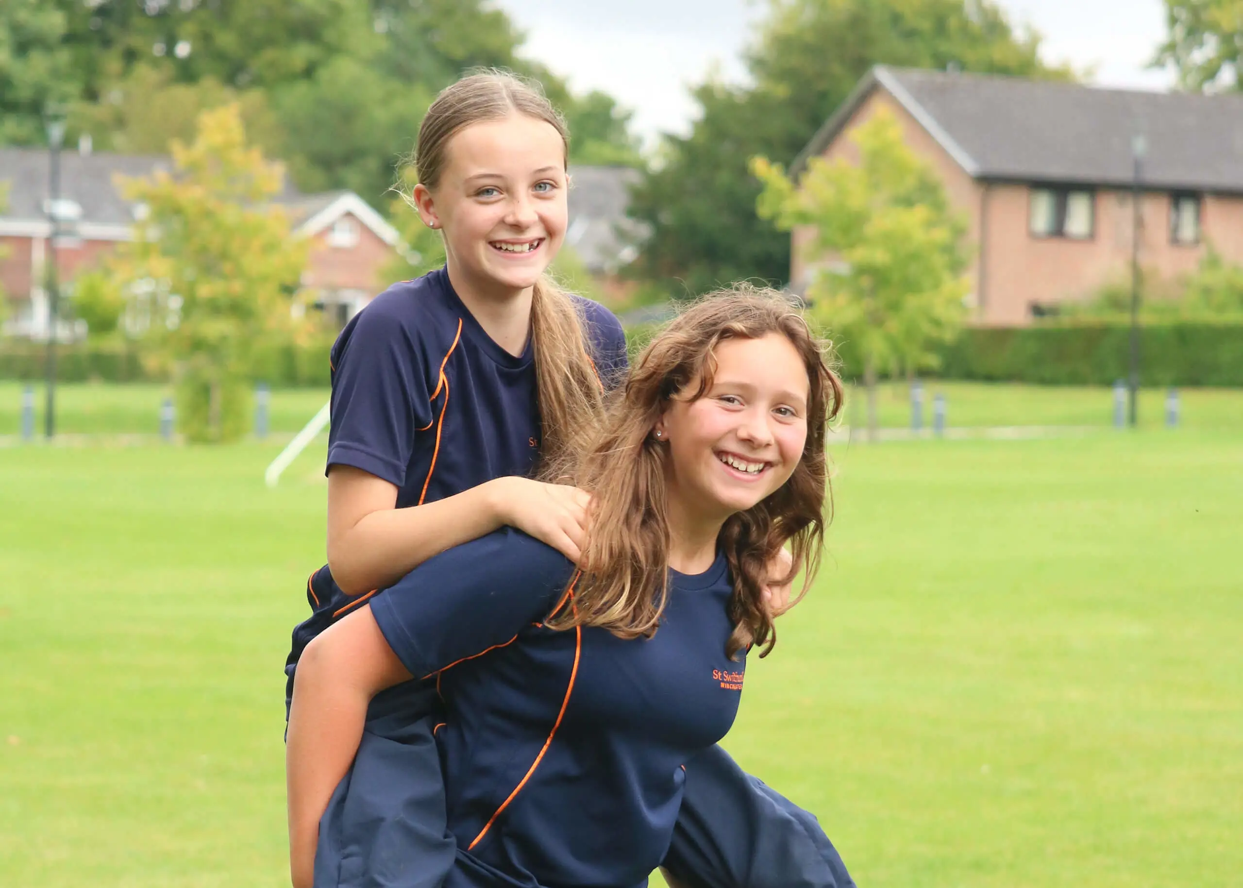 Pupils having fun in the school grounds at St Swithun's